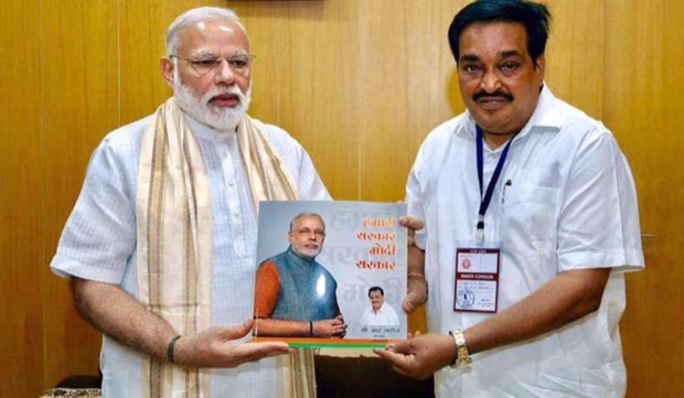 C. R. Patil presenting a bound publication to the Prime Minister of India at a meeting.