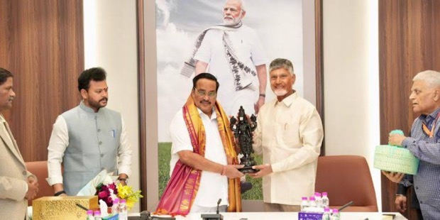 C. R. Patil presenting a sculpted memento to a Chief Minister across a table at an official meeting, with officials on either side.