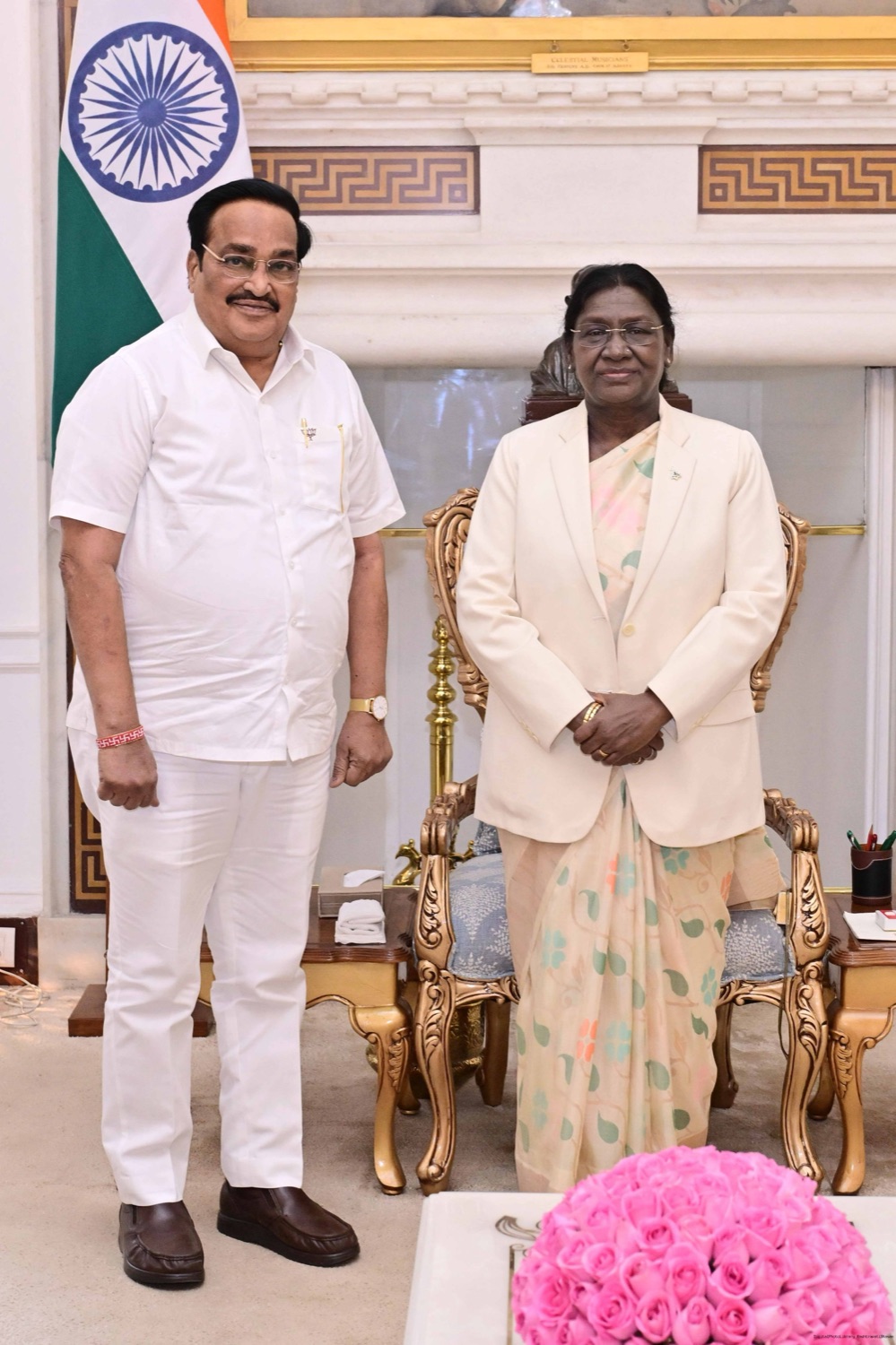 C. R. Patil standing beside the President of India in a formal reception room, with the national flag behind them.