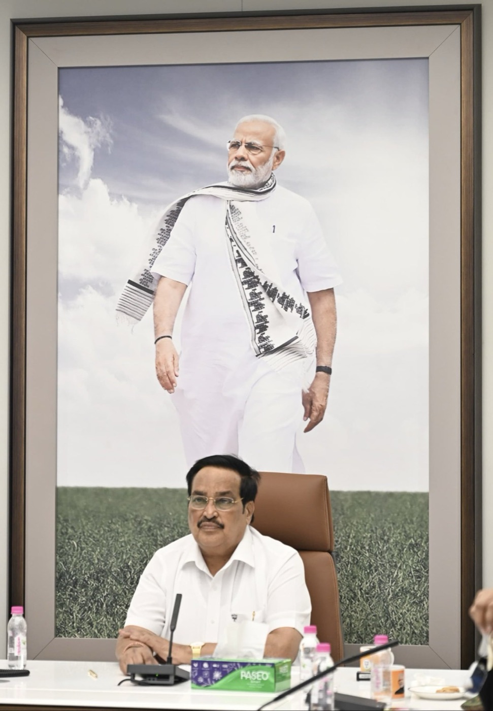 C. R. Patil seated at his desk in the Ministry of Jal Shakti, beneath a large framed photograph of the Prime Minister.
